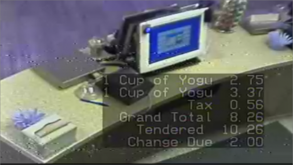 Items added to an order, items removed from an order, totals, tax and more are all shown in white text overlaid on a video security camera image.